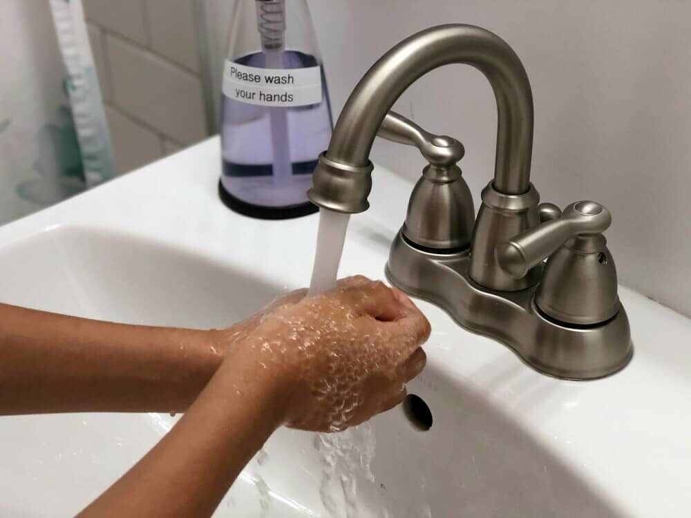 mastering handwashing while water running from faucet